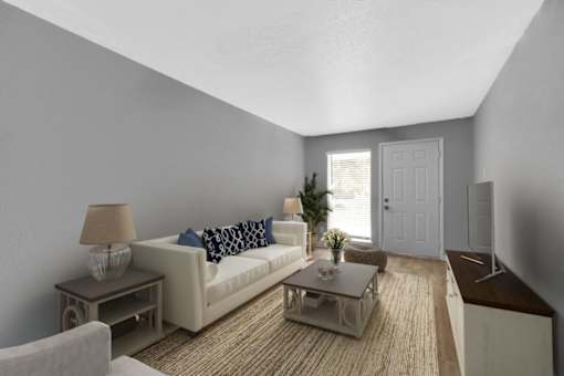 A living room with a white couch and a coffee table.