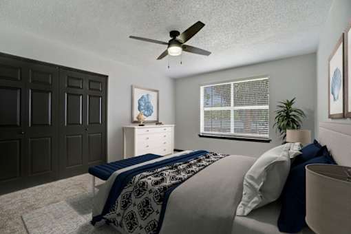 a bedroom with a bed and a ceiling fan