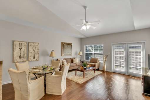 a living room with furniture and a ceiling fan