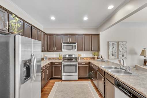 a kitchen with stainless steel appliances and wooden cabinets
