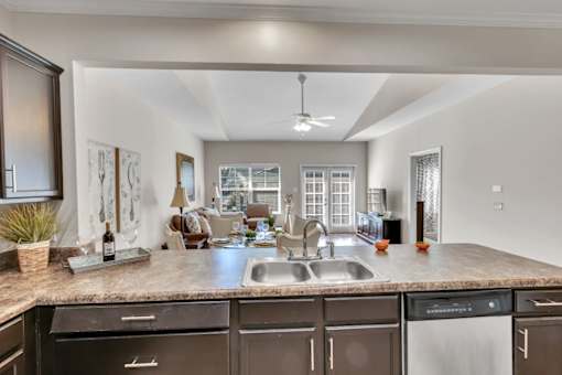 view of living room from kitchen with granite counter top and kitchen island and living room