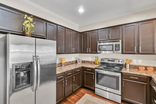 a kitchen with stainless steel appliances and wooden cabinets