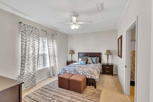 a bedroom with a bed and a ceiling fan