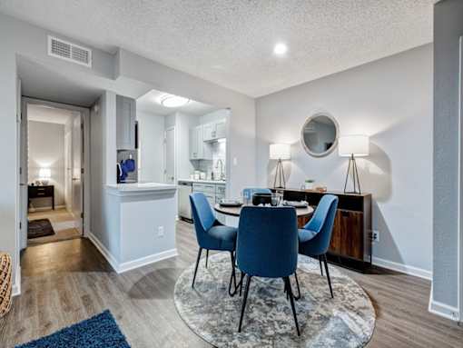 a dining room with a table and chairs and a kitchen