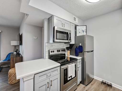 a kitchen with stainless steel appliances and a refrigerator