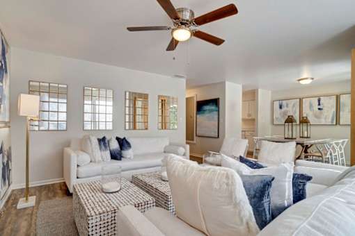 a living room filled with furniture and a ceiling fan at Estates at Palm Bay, Fort Walton Beach, Florida