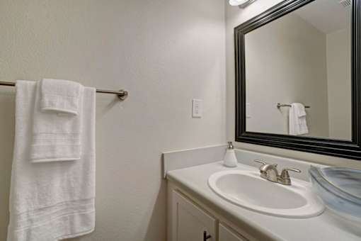 a bathroom with a white sink and a mirror at Estates at Palm Bay, Fort Walton Beach, Florida