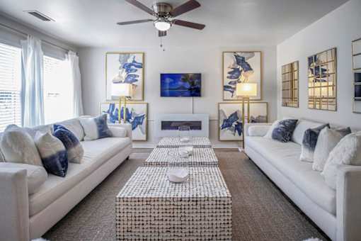 a living room with white furniture and a ceiling fan at Estates at Palm Bay, Fort Walton Beach, FL