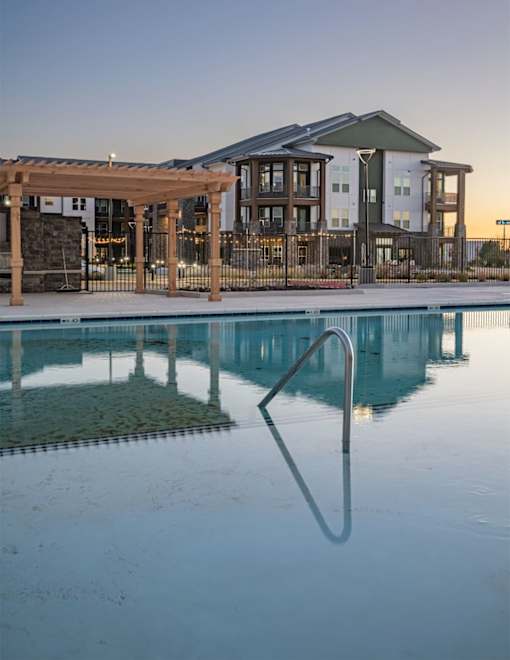 a swimming pool with a building in the background