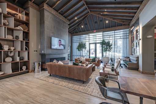 a living room with couches and chairs and a fireplace
