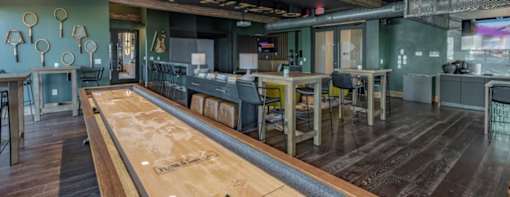 a large room with tables and chairs and a bar