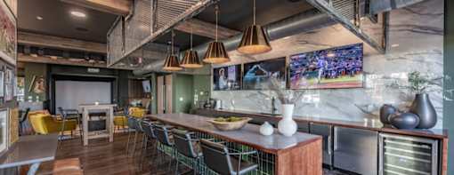 a restaurant with a long bar and a counter with chairs