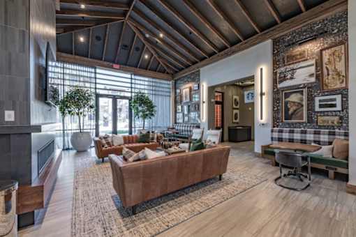 a living room with couches and chairs and a fireplace