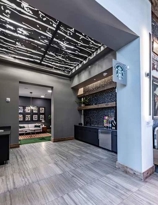 a lobby with a bar and a clock on the wall