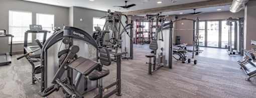a gym with weights and other exercise equipment in a building