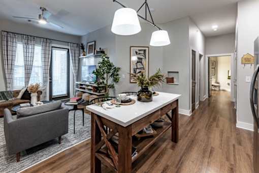 a living room and dining room with a table