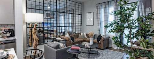 a living room filled with furniture and a large window