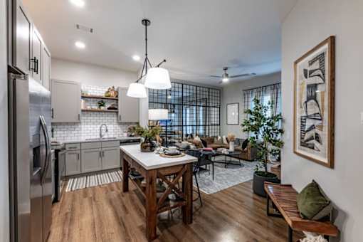 an open kitchen and living room area with a dining table