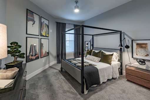 a bedroom with a bed and a dresser and a window