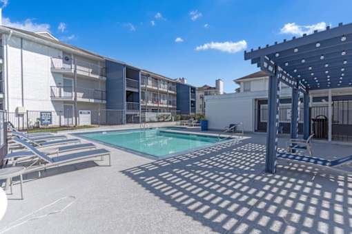 our apartments have a pool and covered area with lounge chairs