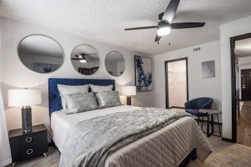 a bedroom with a bed and a ceiling fan at The Lorient Apartments, Pensacola