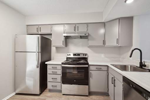 a kitchen with stainless steel appliances and white cabinets