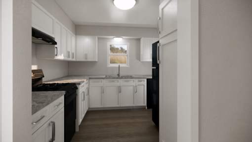 A kitchen with white cabinets and a black refrigerator.