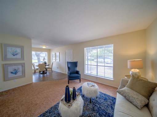 a living room with a couch and a table at Villas del Tesoro Apartments, Texas, 75228
