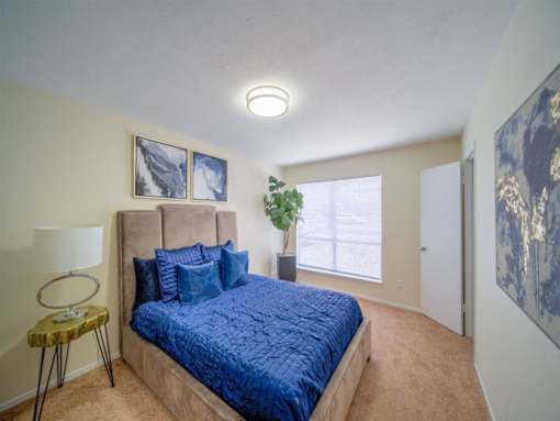 a bedroom with a large bed and a window at Villas del Tesoro Apartments, Dallas, TX
