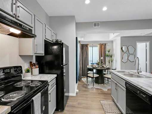 an empty kitchen with a stove and a refrigerator