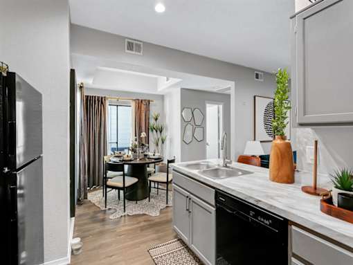 an open kitchen and dining room with a table and chairs