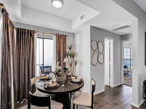 an open living room and dining room with a table and chairs