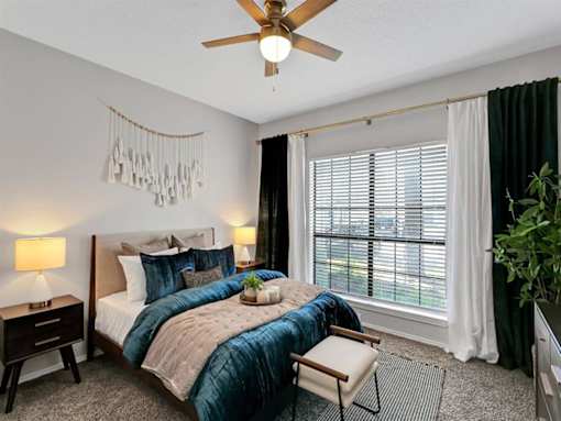 a bedroom with a bed and a ceiling fan