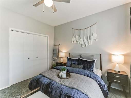 a bedroom with a bed and a ceiling fan