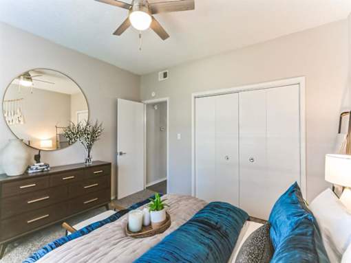 a bedroom with a bed and a ceiling fan