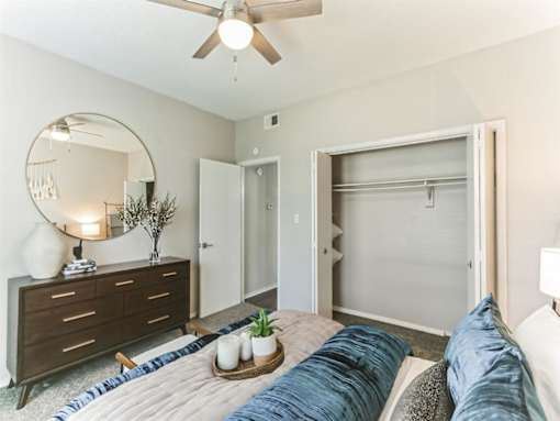 a bedroom with a bed and a ceiling fan