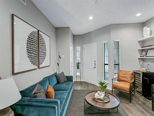 a living room with a blue couch and a coffee table