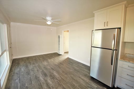 a kitchen with a stainless steel refrigerator and white cabinets