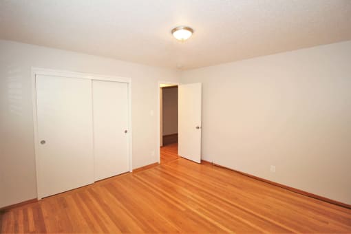 full view of living room with wood flooring and white walls
