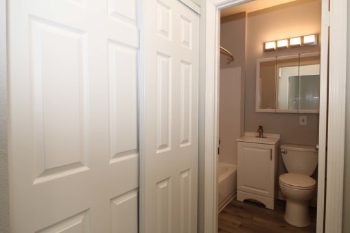 a bathroom with a toilet and a white door