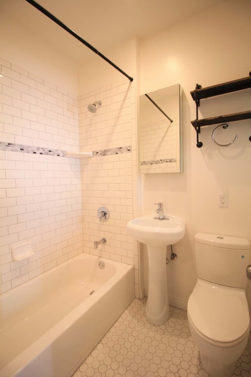 a white bathroom with a toilet sink and tub