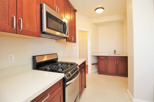 full kitchen with stainless steel appliances and a microwave