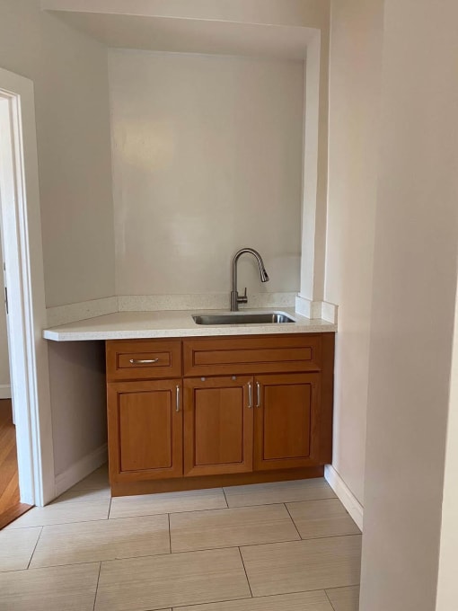 a kitchen with a sink and wooden cabinets