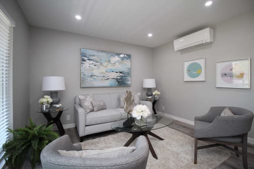 a living room with a couch and chairs