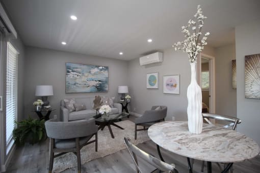 a living room with a table and chairs and a couch