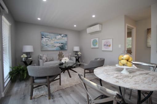 a dining room and living room with a table and chairs