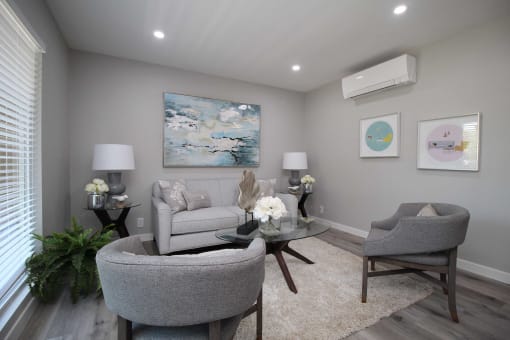 a living room with two chairs and a couch