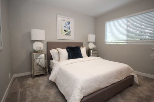 a bedroom with a large bed and a window