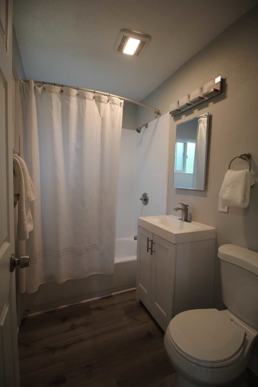 a small bathroom with a toilet sink and shower