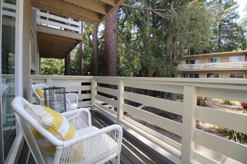 a porch with a chair and a table on it